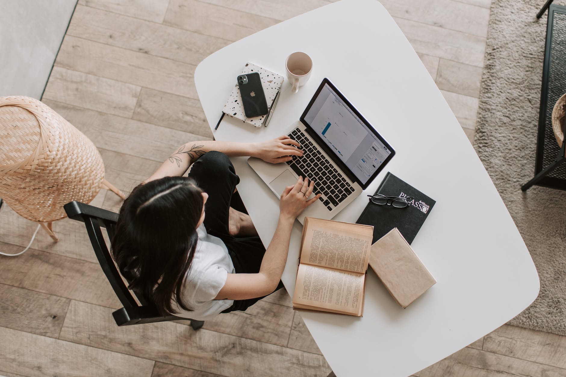 Bird's-eye view of a woman working on a laptop.